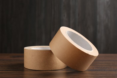 Two masking tapes on wooden table, closeup