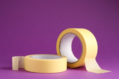 Rolls of masking tapes on violet background