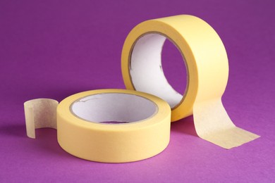 Rolls of masking tapes on violet background