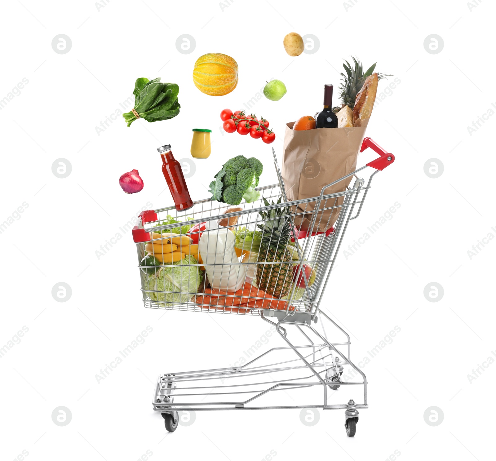 Image of Groceries falling into shopping cart on white background