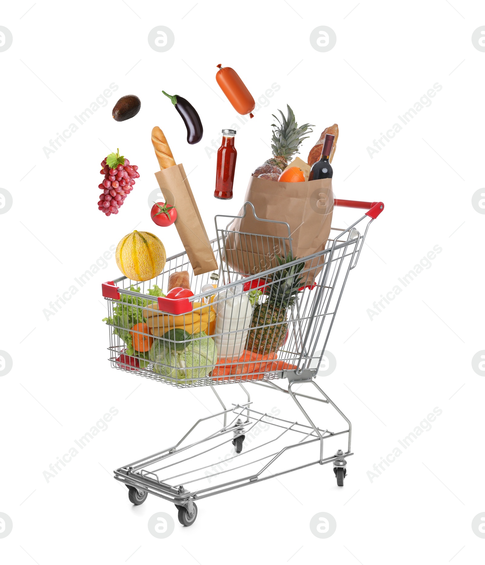 Image of Groceries falling into shopping cart on white background