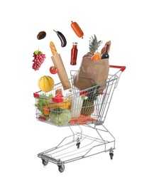 Image of Groceries falling into shopping cart on white background