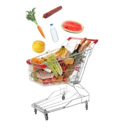 Image of Groceries falling into shopping cart on white background