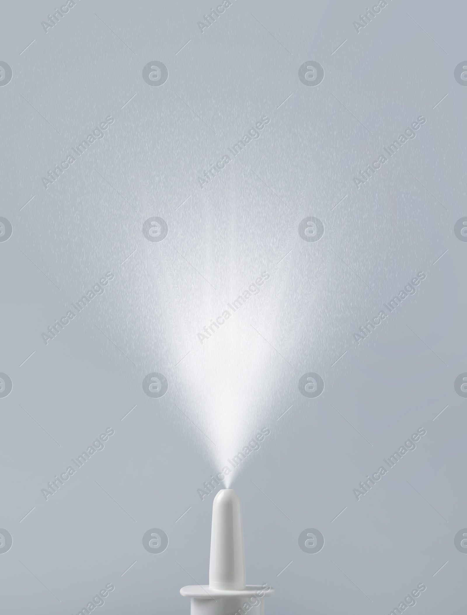 Image of Nasal spray with sprinkled medication over nozzle on grey background, closeup