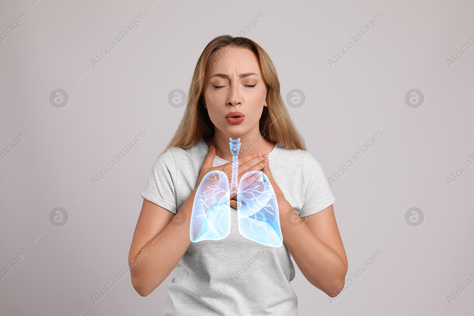 Image of Woman with asthma suffering from difficulty breathing on grey background. Illustration of lungs