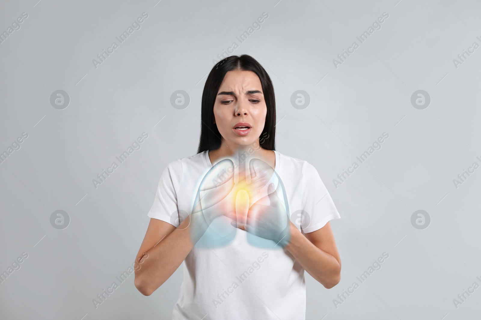 Image of Woman with asthma suffering from difficulty breathing on grey background. Illustration of lungs