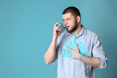 Young man using asthma inhaler on turquoise background with space for text. Illustration of lungs