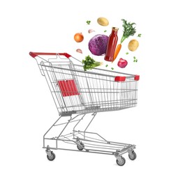 Image of Groceries falling into shopping cart on white background