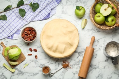 Photo of Flat lay composition with raw homemade apple pie and ingredients on white marble table