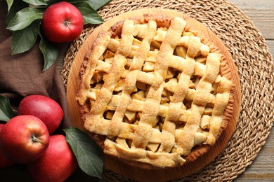 Photo of Flat lay composition with tasty homemade apple pie, fruits and leaves on wooden table