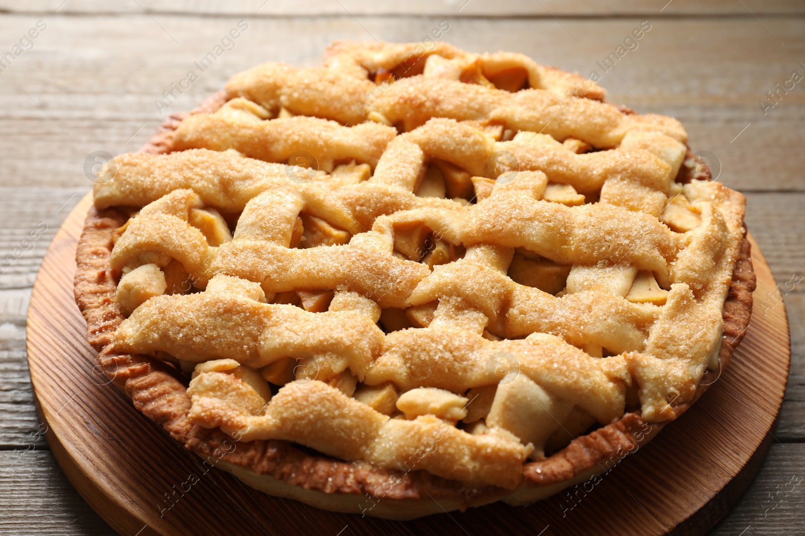 Photo of Tasty homemade apple pie on wooden table, closeup