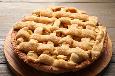 Photo of Tasty homemade apple pie on wooden table, closeup