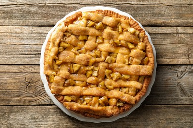 Photo of Homemade apple pie on wooden table, top view