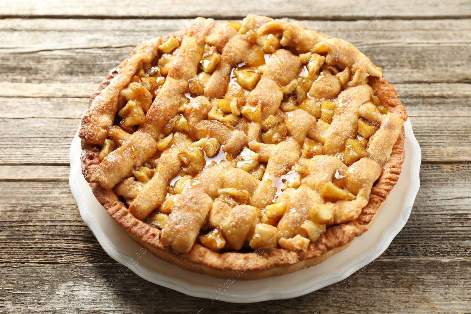 Photo of Tasty homemade apple pie on wooden table