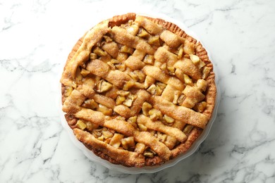 Photo of Homemade apple pie on white marble table, top view