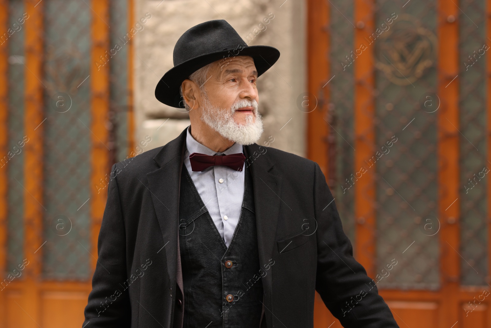 Photo of Bearded senior man in elegant outfit outdoors