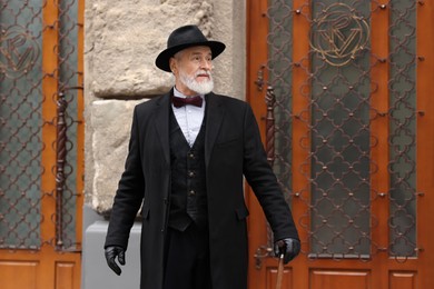 Photo of Bearded senior man in elegant outfit outdoors