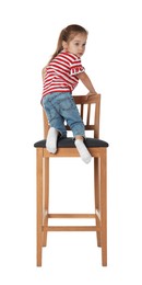 Photo of Little girl sitting on stool against white background