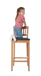 Photo of Little girl sitting on stool against white background