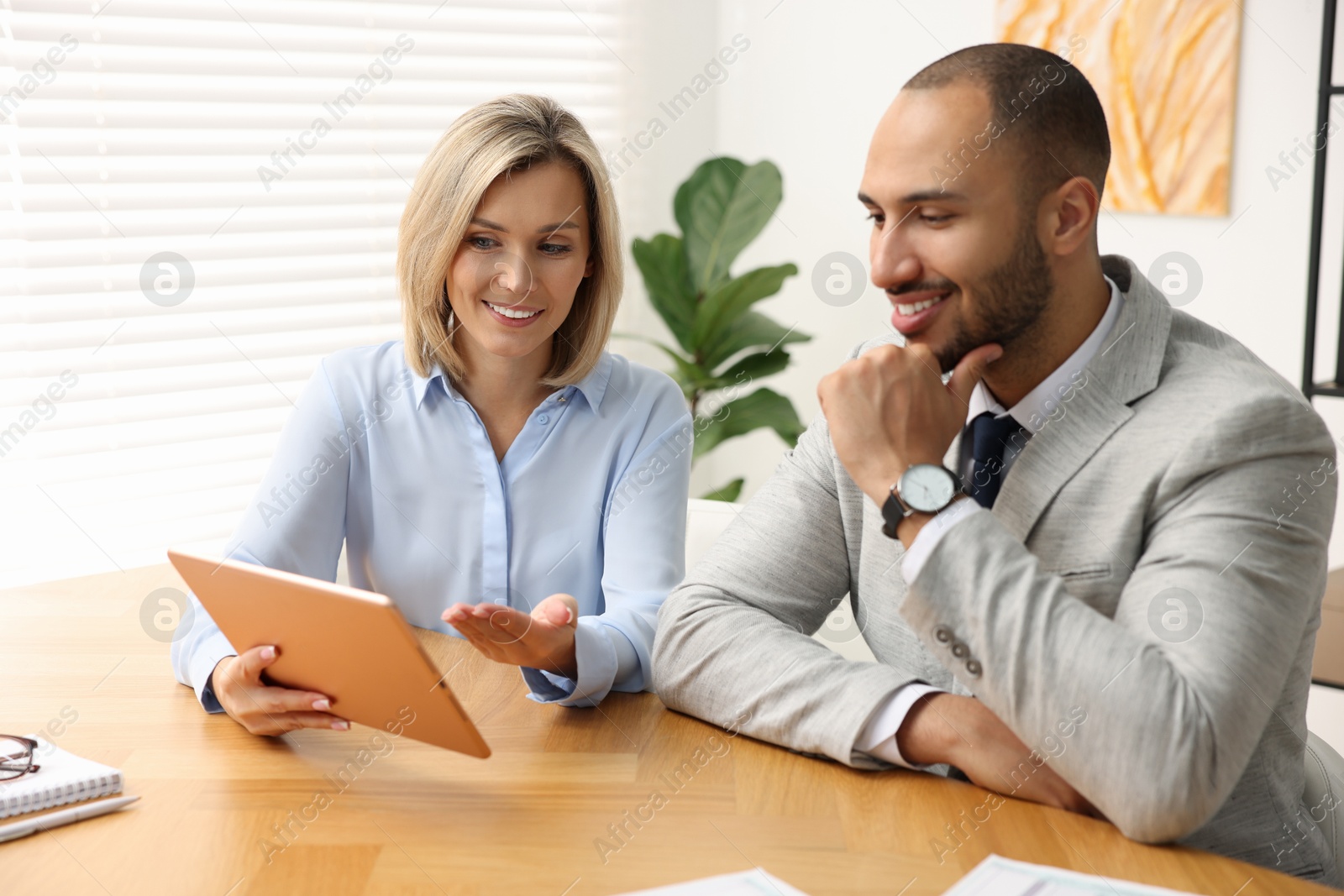 Photo of Coworkers with tablet working together in office