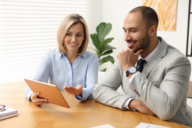 Photo of Coworkers with tablet working together in office