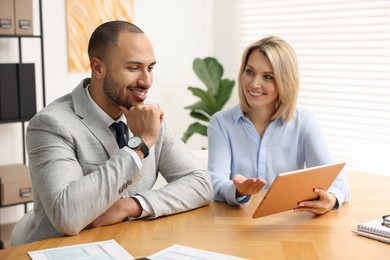 Photo of Coworkers with tablet working together in office