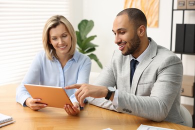 Photo of Coworkers with tablet working together in office