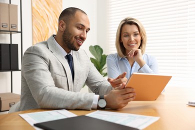 Coworkers with tablet working together in office