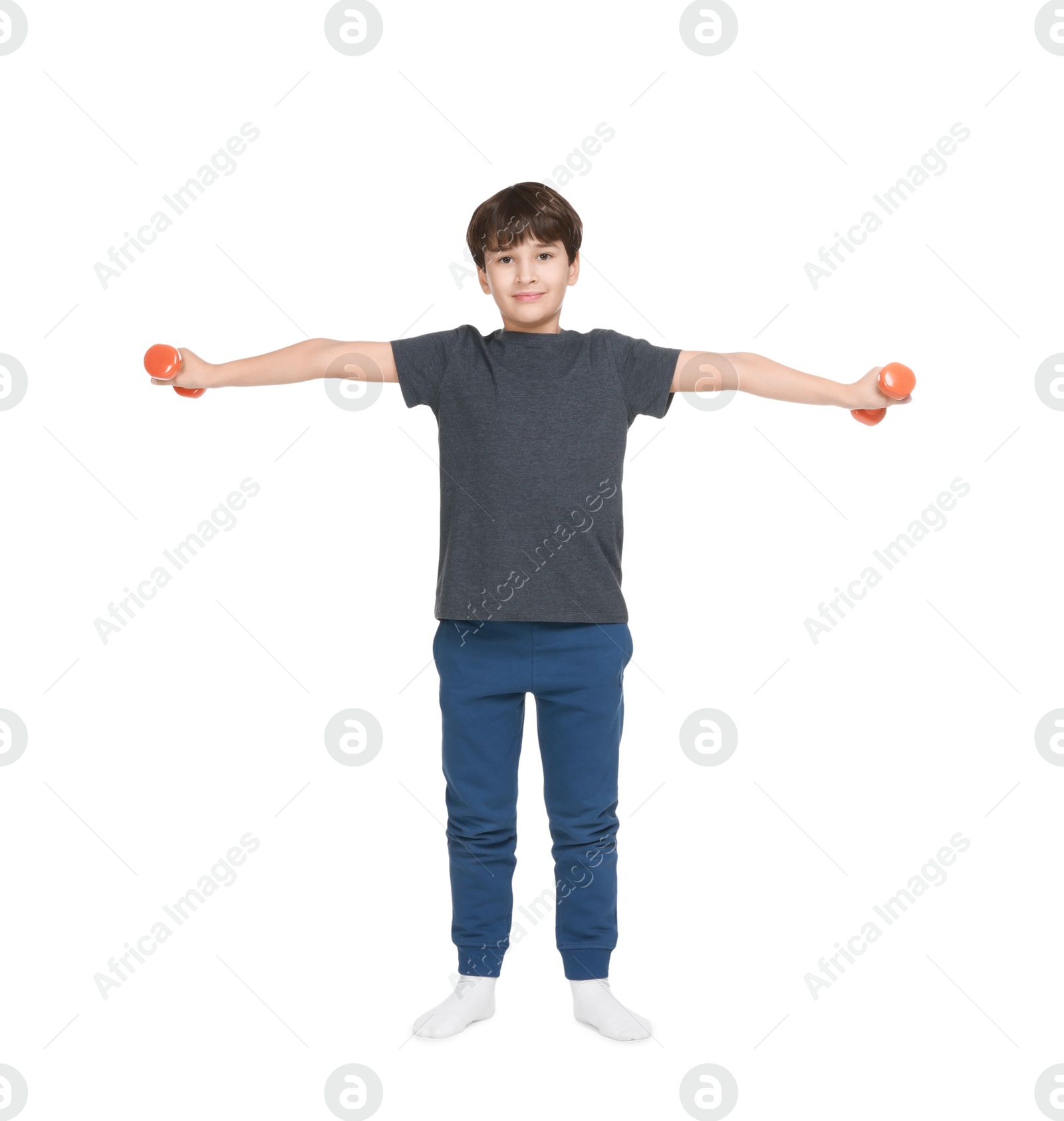 Photo of Boy doing exercise with dumbbells on white background. Sport activity