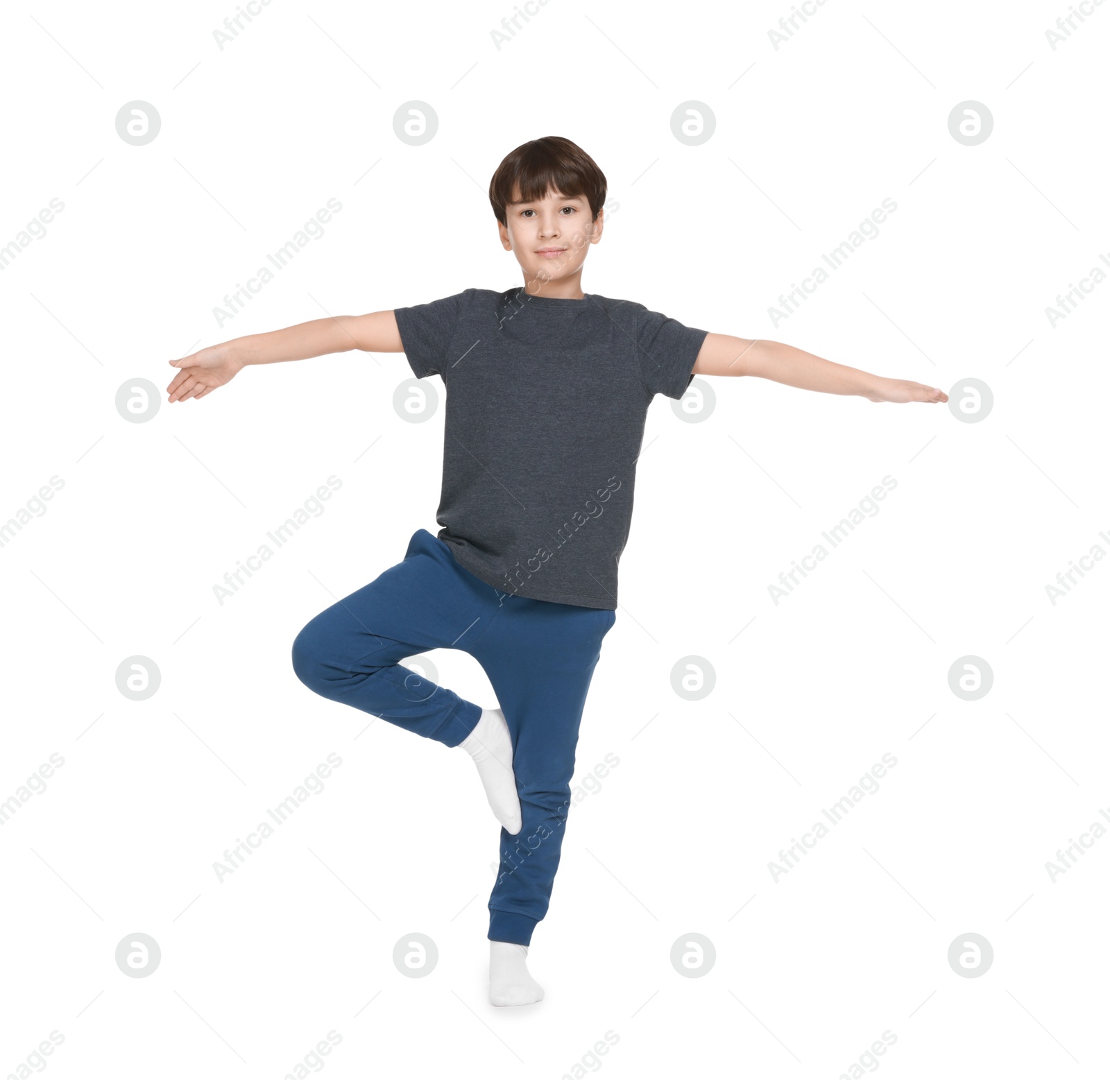 Photo of Boy doing exercise on white background. Sport activity