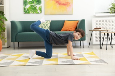 Photo of Boy doing exercise at home. Sport activity