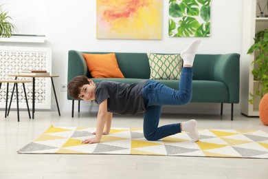 Photo of Boy doing exercise at home. Sport activity