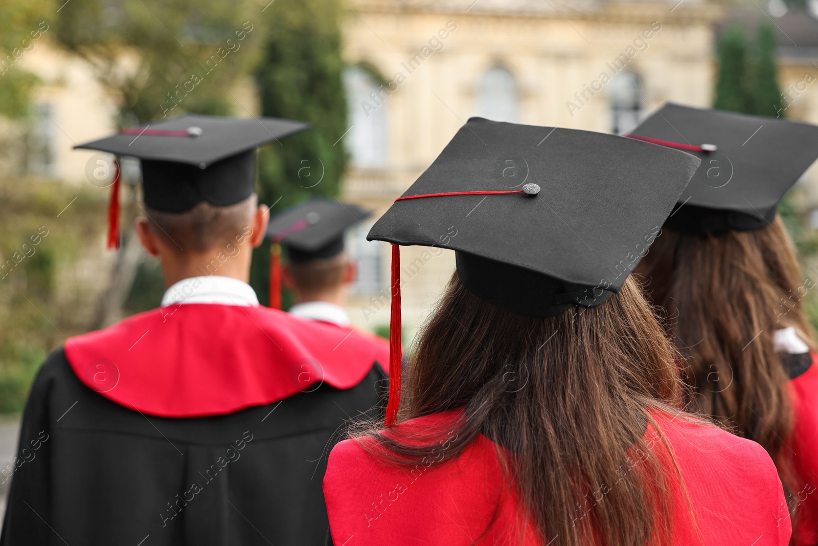 Photo of Students at graduation ceremony outdoors, back view