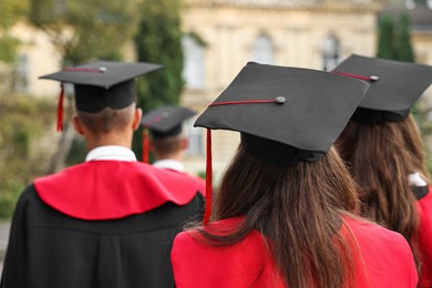 Students at graduation ceremony outdoors, back view