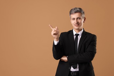 Photo of Portrait of businessman on brown background, space for text