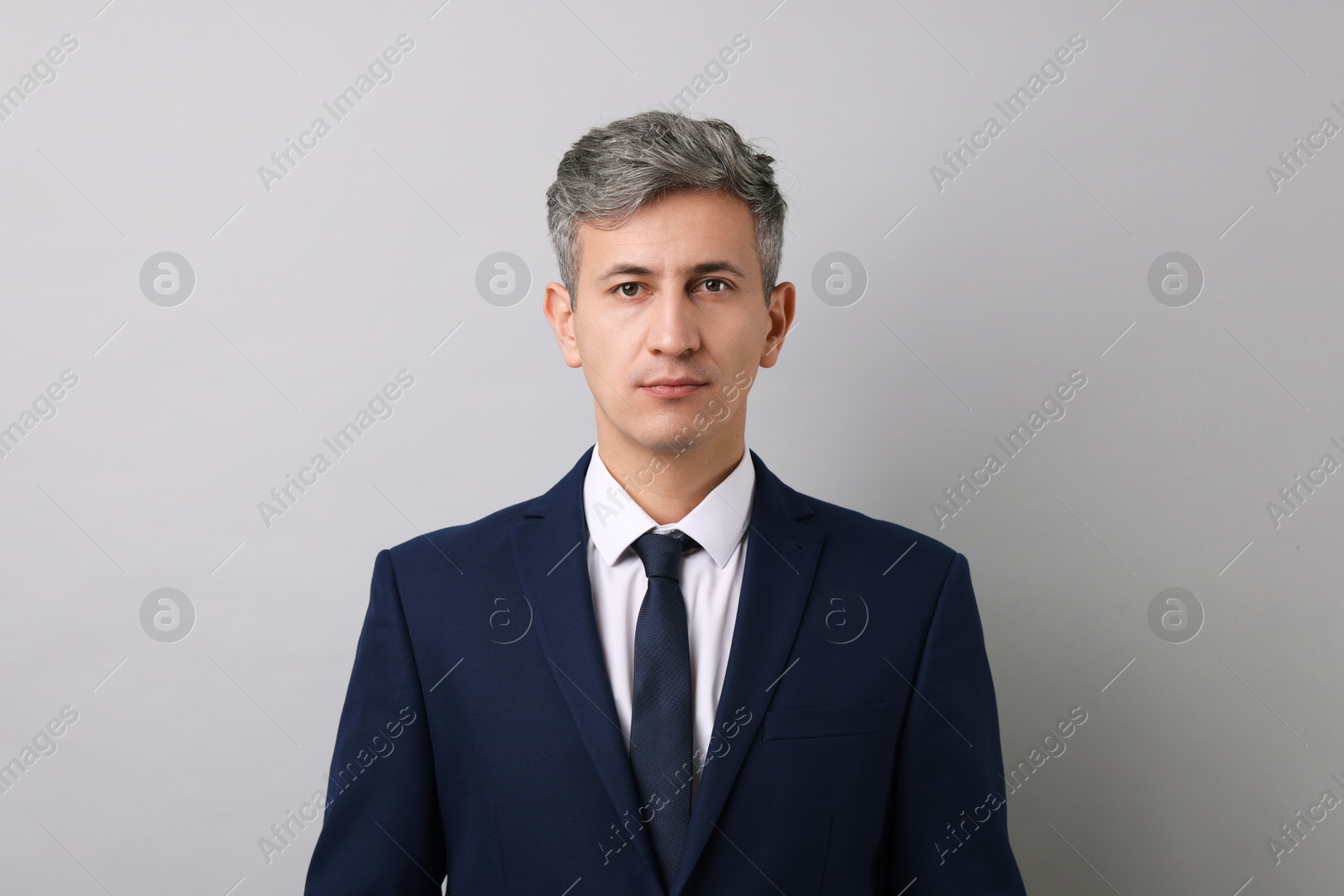 Photo of Portrait of businessman on light grey background