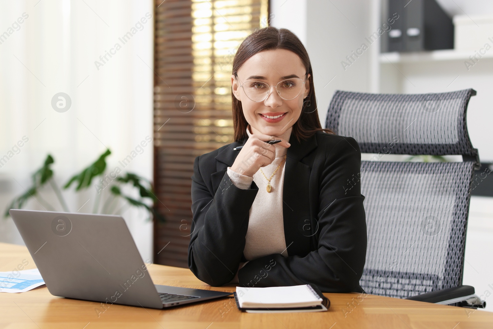 Photo of Businesswoman with glasses at table in office