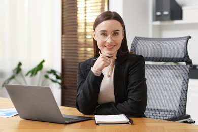 Photo of Businesswoman with glasses at table in office