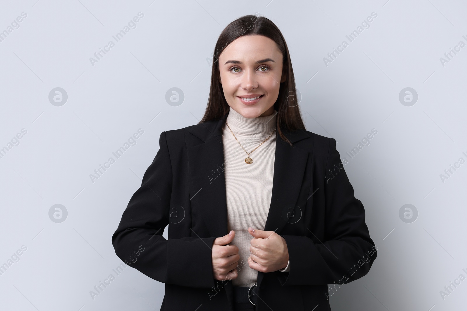 Photo of Portrait of businesswoman on light grey background