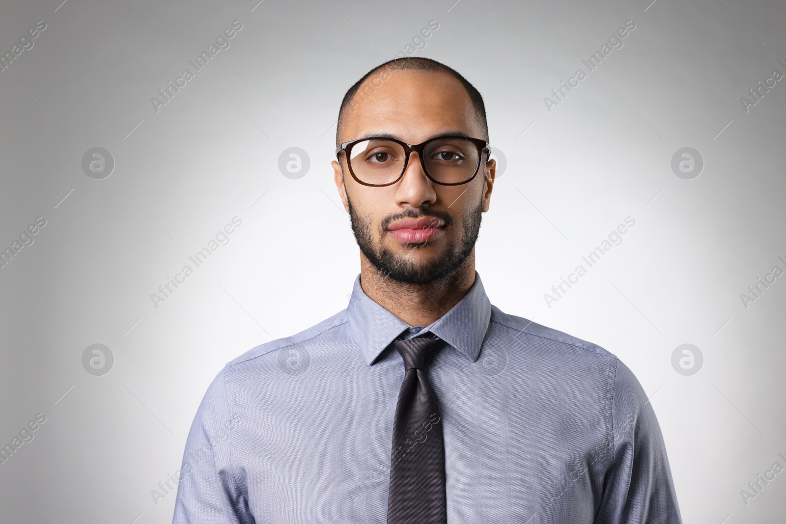 Photo of Portrait of businessman in glasses on light gray background