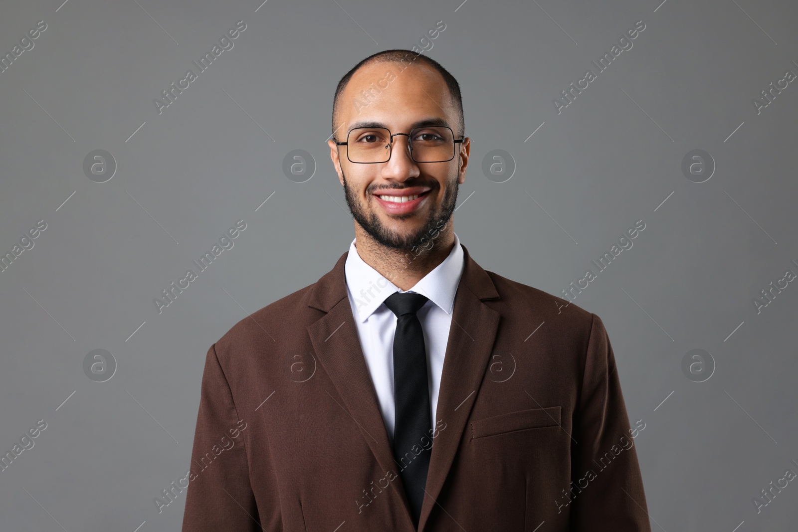 Photo of Portrait of businessman in glasses on gray background