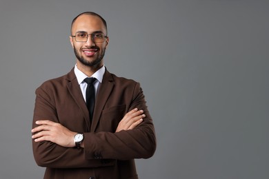 Photo of Portrait of businessman in glasses on gray background, space for text