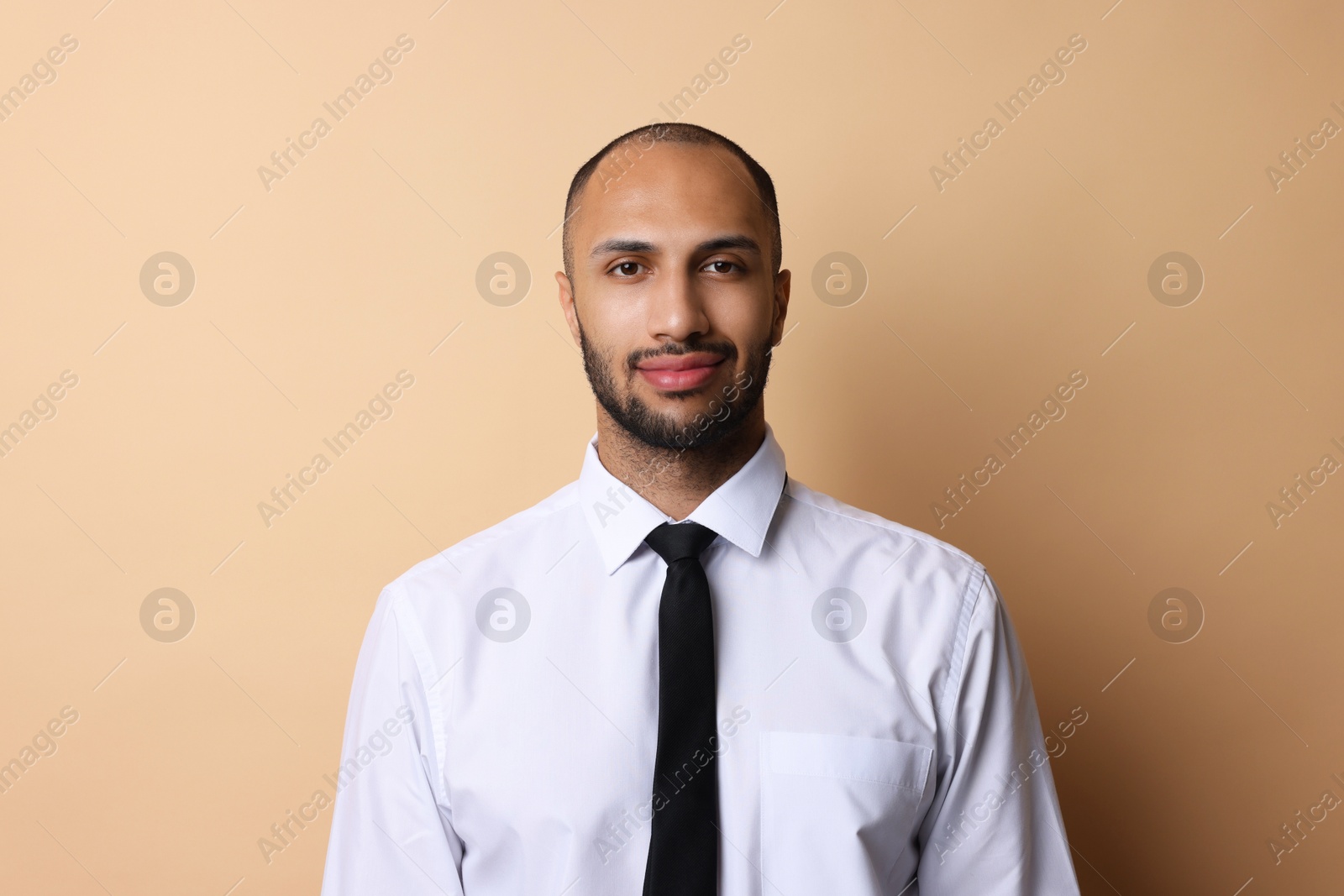 Photo of Portrait of businessman with necktie on beige background