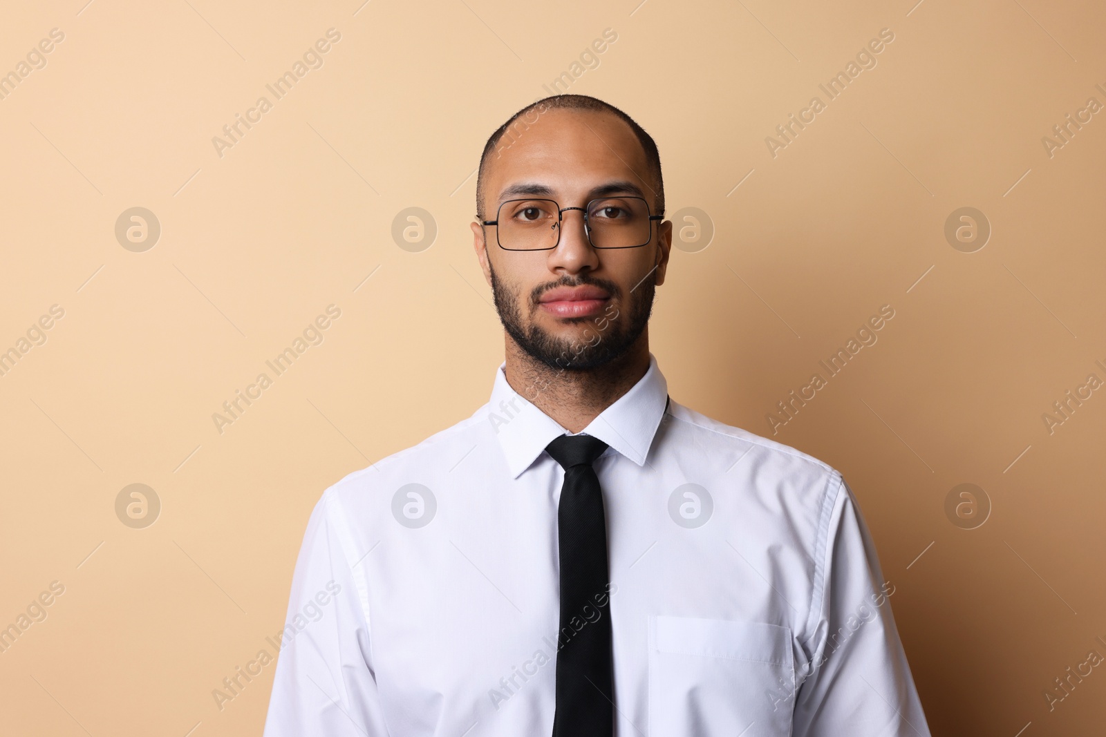 Photo of Portrait of businessman in glasses on beige background