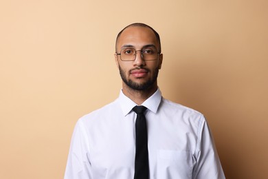 Photo of Portrait of businessman in glasses on beige background