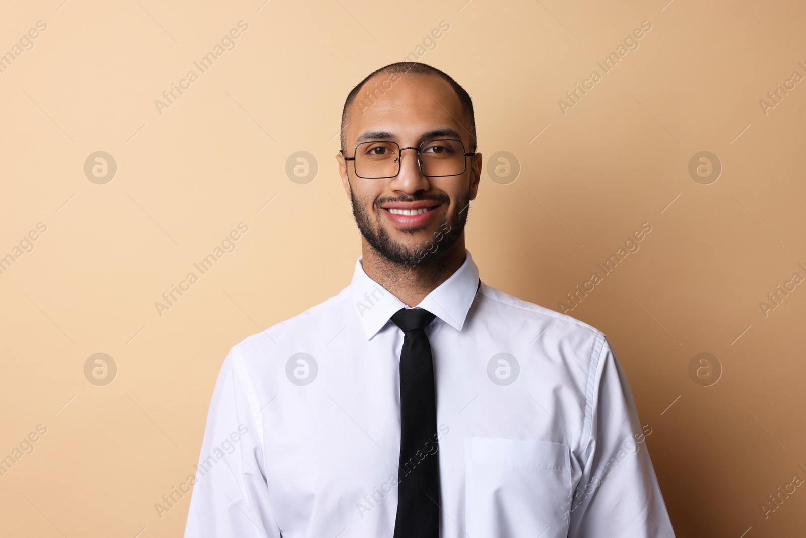 Photo of Portrait of businessman in glasses on beige background