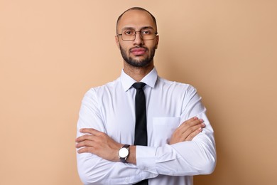 Portrait of businessman in glasses on beige background