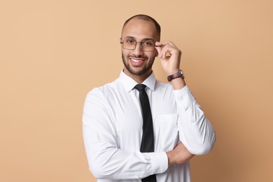 Photo of Portrait of businessman in glasses on beige background