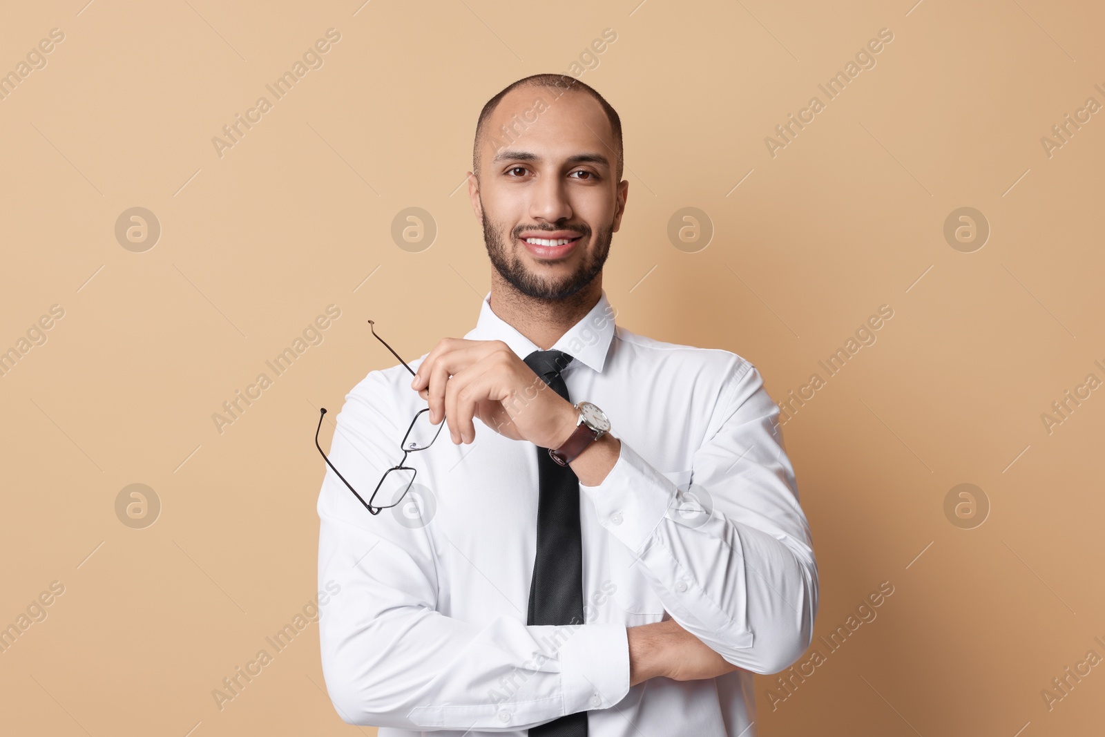 Photo of Portrait of businessman with glasses on beige background