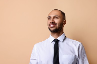 Photo of Portrait of businessman on beige background, space for text